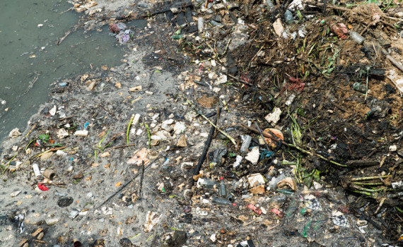 Water pollution in river with trash.